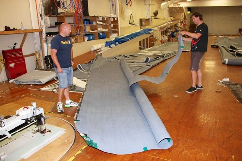 Matt Smeaton (left) and Burns Fallow (right) unroll a J class jib blank in the North loft in Auckland © Richard Gladwell www.photosport.co.nz